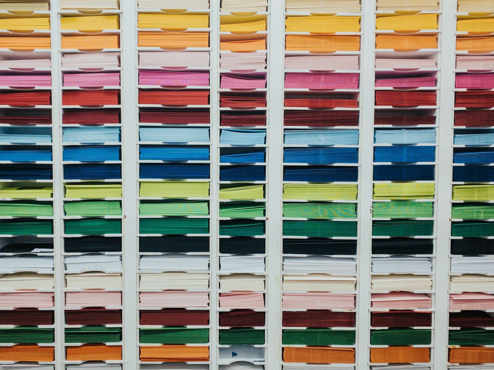 A wall filled with different pantones of coloured paper
